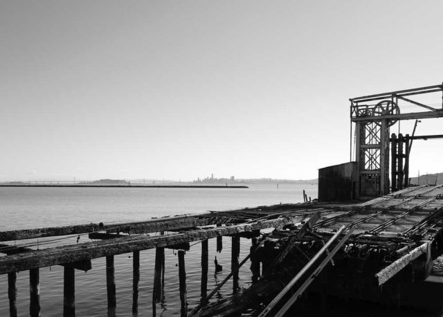 B/W view of skeletal Ferry Point ruins, with SF in the background.