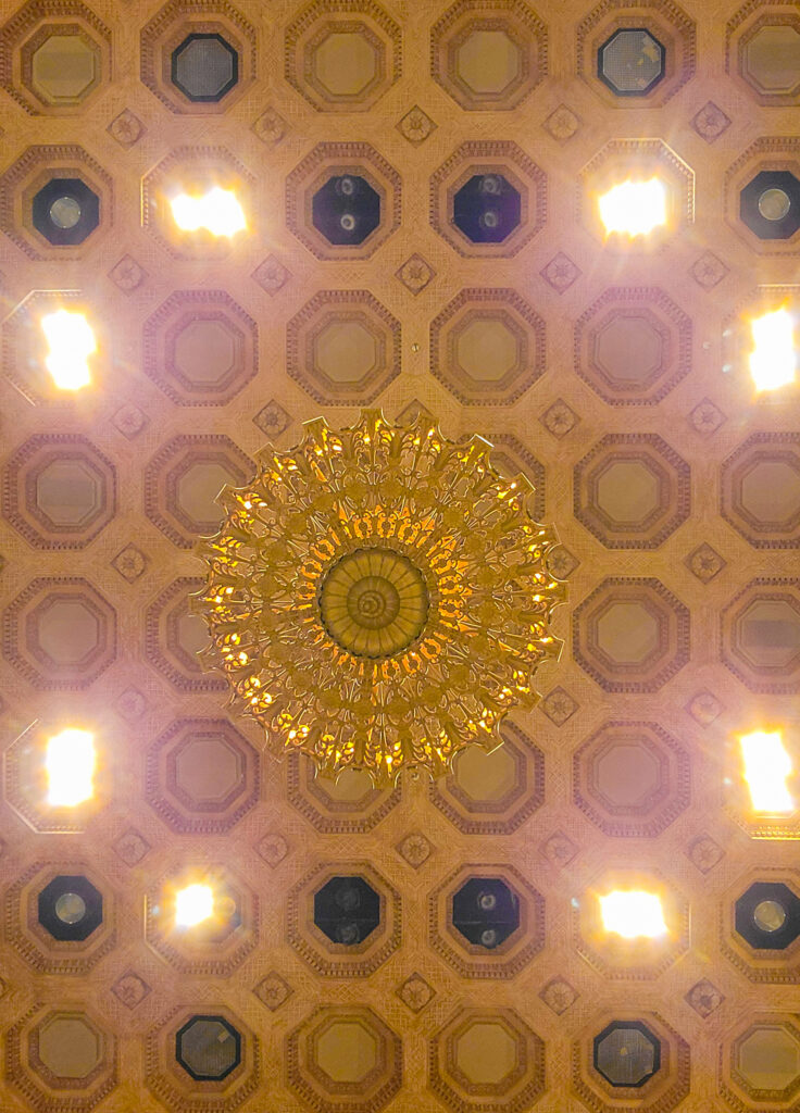 Brightly lit decorative ceiling of the Great Hall